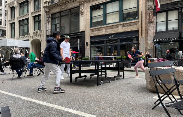 Two people play ping pong in the Flatiron District of Manhattan.