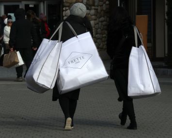CENTRAL VALLEY, NY - NOVEMBER 17:  A person carries bags from Frette at the Woodbury Common Premium Outlets shopping mall on November 17, 2019 in Central Valley, New York. (Photo by Gary Hershorn/Corbis via Getty Images)