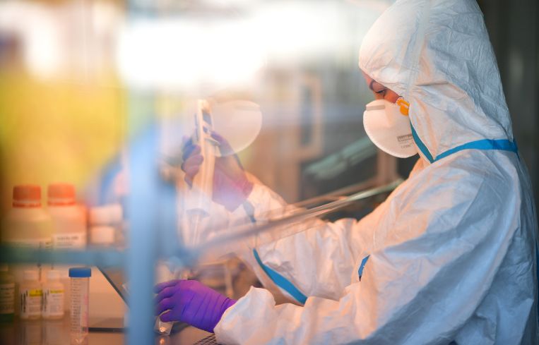 A lab technician analyses swab samples for possible Covid-19 infection.