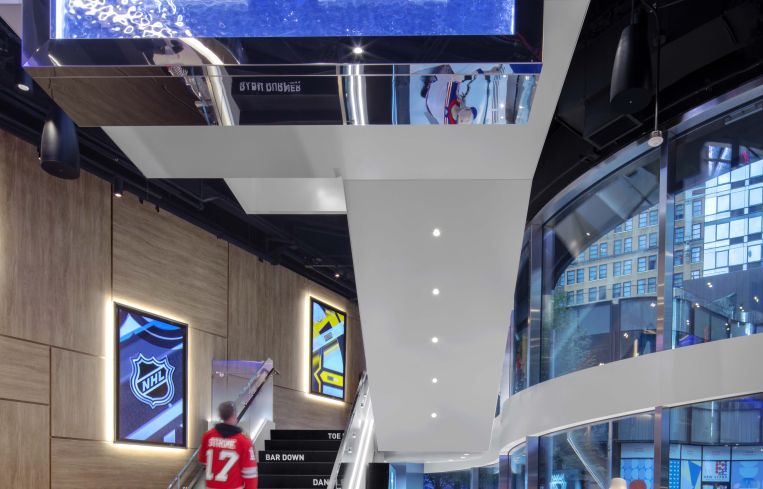 Historic team jerseys are suspended over the stairway in resin that's meant to resemble a block of ice.