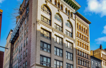 The eight-story white and green building at 419 Lafayette Street.