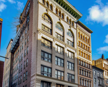 The eight-story white and green building at 419 Lafayette Street.