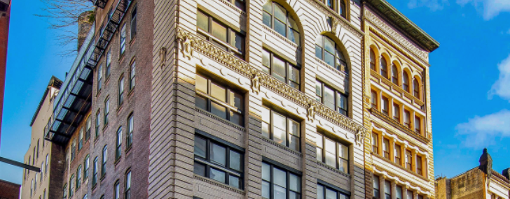 The eight-story white and green building at 419 Lafayette Street.