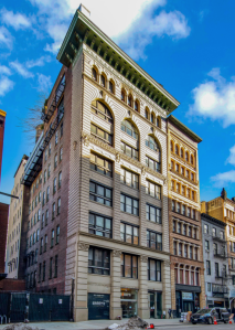 The eight-story white and green building at 419 Lafayette Street.