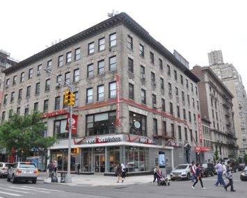 The shorter brown building with a shop on the ground floor at 2231 Broadway.