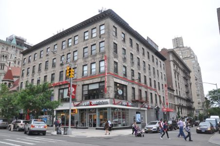The shorter brown building with a shop on the ground floor at 2231 Broadway.