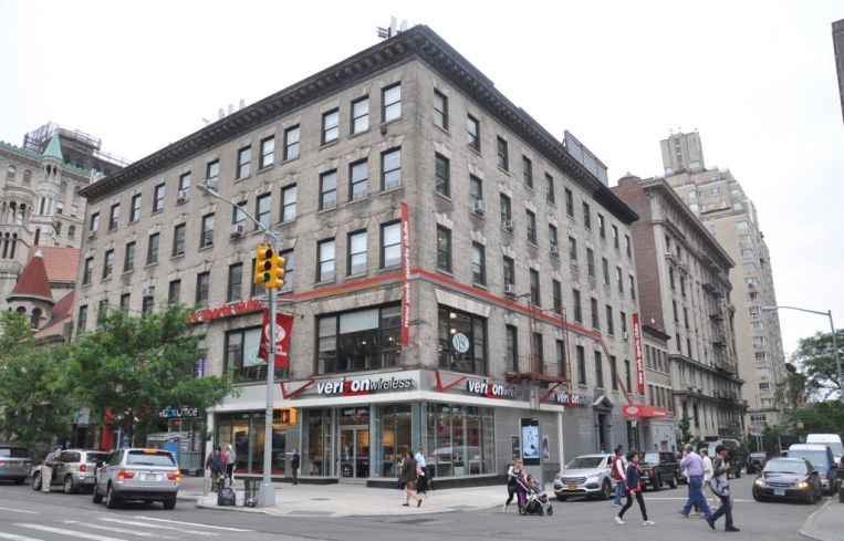 The shorter brown building with a shop on the ground floor at 2231 Broadway.