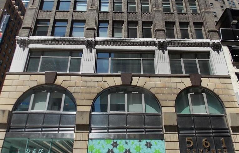 The grey and white office building at 561 Seventh Avenue.