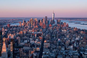 The Manhattan skyline is seen at sunrise from the 86th floor observatory of the Empire State Building on April 3, 2021.
