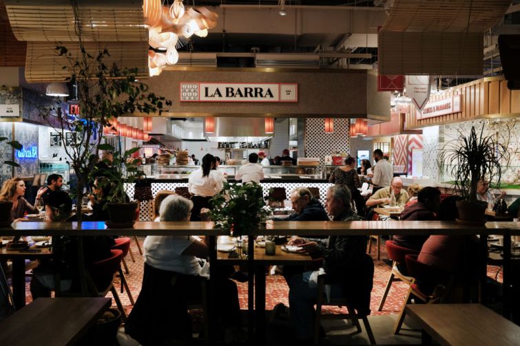 People eat at a restaurant in Hudson Yards' Spanish Market, Mercado Little Spain, on May 12, 2022 in New York City.
