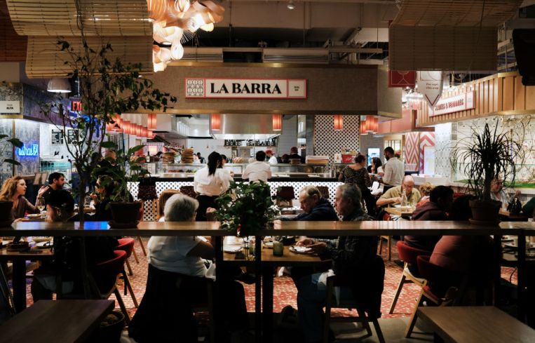 People eat at a restaurant in Hudson Yards' Spanish Market, Mercado Little Spain, on May 12, 2022 in New York City.