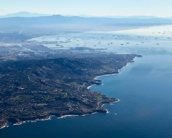 An aerial image taken October 2021 shows the Palos Verdes Peninsula and cargo container ships waiting in the Pacific Ocean to unload at the Port of Los Angeles and Port of Long Beach.