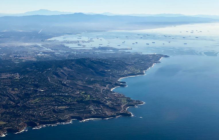 An aerial image taken October 2021 shows the Palos Verdes Peninsula and cargo container ships waiting in the Pacific Ocean to unload at the Port of Los Angeles and Port of Long Beach.