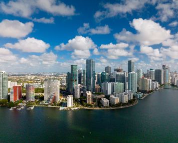 View of Miami Florida skyline with clouds on Atlantic Ocean.