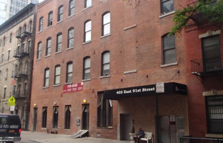 The red brick four-story building at 403 East 91st Street.
