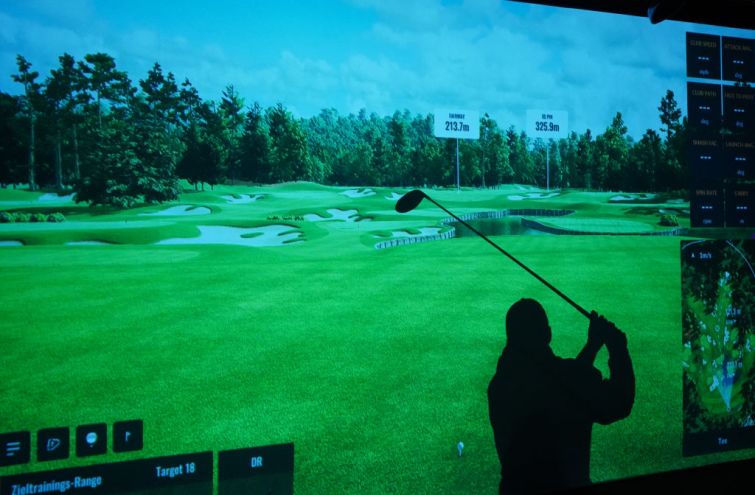 A person at an indoor golf range