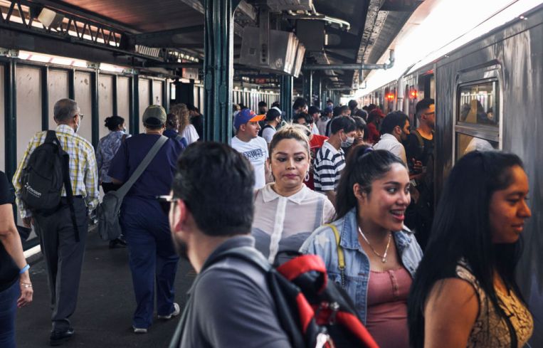 Commuters boarding the 7 Train at Roosevelt Avenue, in Jackson