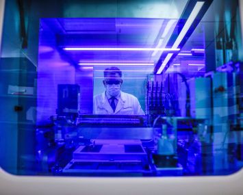 Portrait of Northwell Health Labs Executive Director Dwayne Breining in the COVID-19 testing area of Northwell's core laboratory in Lake Success, New York on June 7, 2022. He is viewed through the window of their Roche Diagnostics Cobas 8800 testing machine.
