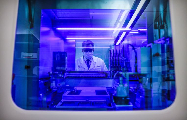 Portrait of Northwell Health Labs Executive Director Dwayne Breining in the COVID-19 testing area of Northwell's core laboratory in Lake Success, New York on June 7, 2022. He is viewed through the window of their Roche Diagnostics Cobas 8800 testing machine.