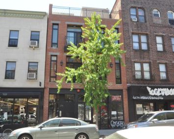 The short, three story building at 276 Grand Street.