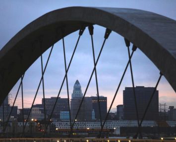 City Hall is framed by one of the arches from the new Sixth Street Viaduct in Los Angeles.