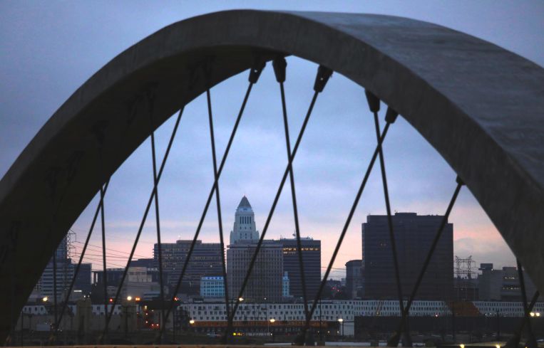 City Hall is framed by one of the arches from the new Sixth Street Viaduct in Los Angeles.