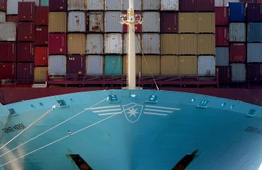 Cargo containers are stacked high aboard a ship in the Port of Los Angeles. many businesses are thinking about bringing their operations and production of goods back to the U.S., a switch called “reshoring.”