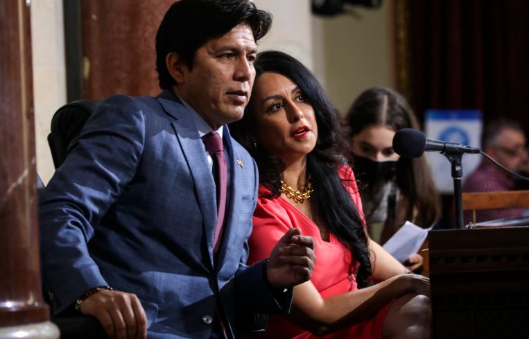 Los Angeles City Councilman Kevin de León, left, and City Council President Nury Martinez confer on Tuesday.