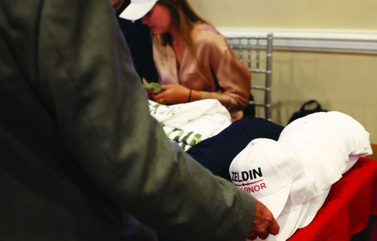 A supporter takes a campaign hat on June 28, 2022 in Baldwin, New York.