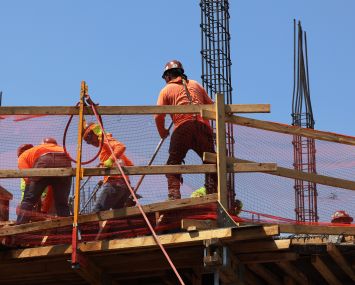 Construction workers work on a site on Lenox Avenue on July 22, 2022 in the Flatbush neighborhood of the Brooklyn.