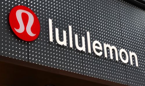The corporate logo for Lululemon hangs on a wall at their store in August, 2022.