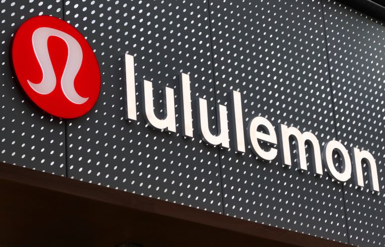 The corporate logo for Lululemon hangs on a wall at their store in August, 2022.