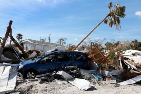 A damaged vehicle sits among debris after hurricane Ian in Fort Myers Beach, Fla.  