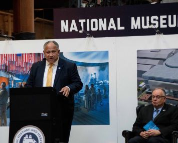 Secretary of the Navy Carlos Del Toro speaking to audience members at the National Museum of the U.S. Navy during a ceremony celebrating the Navy’s 247th birthday.