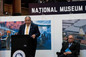 Secretary of the Navy Carlos Del Toro speaking to audience members at the National Museum of the U.S. Navy during a ceremony celebrating the Navy’s 247th birthday.