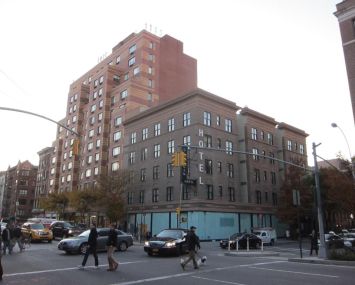 The shorter brick building and ground floor retail space at 300 West 22nd Street.