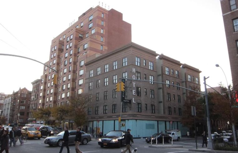 The shorter brick building and ground floor retail space at 300 West 22nd Street.
