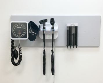 Inside doctor's office with basic equipment on the wall.
