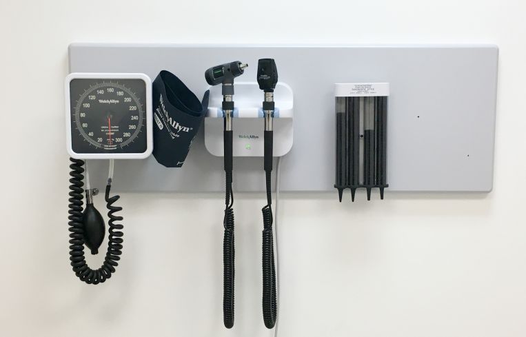 Inside doctor's office with basic equipment on the wall.