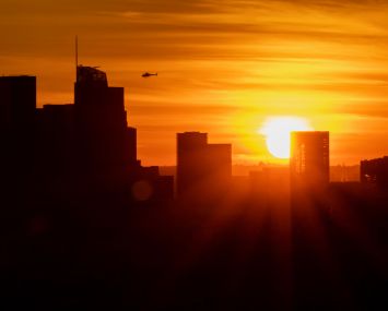 The sun sets behind Downtown Los Angeles during the first sunset of winter on December 21. Downtown Los Angeles currently has more than 40 projects under construction and another 130 in the planning process.