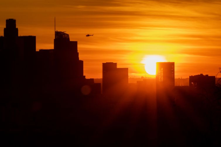 The sun sets behind Downtown Los Angeles during the first sunset of winter on December 21. Downtown Los Angeles currently has more than 40 projects under construction and another 130 in the planning process.