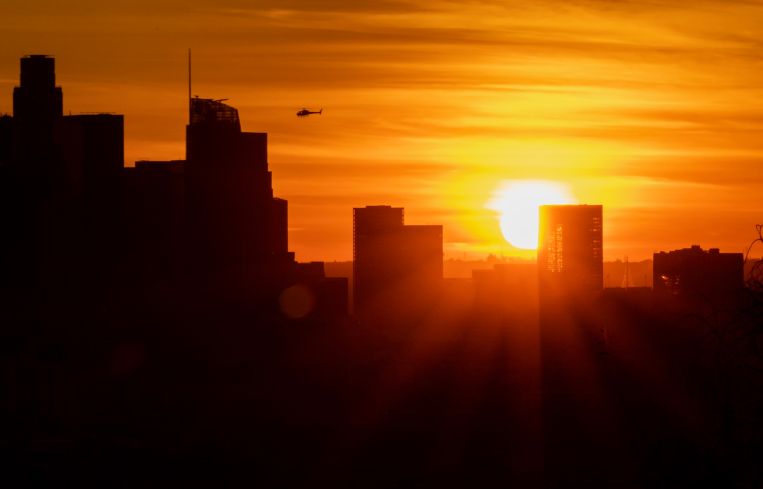 The sun sets behind Downtown Los Angeles during the first sunset of winter on December 21. Downtown Los Angeles currently has more than 40 projects under construction and another 130 in the planning process.