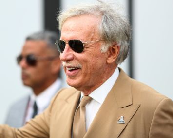Owner Stan Kroenke of the Los Angeles Rams smiles and waves to fans in the tunnel prior to an NFL football game in November.