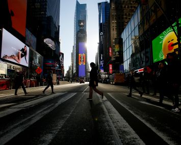 People walk through Times Square on December 2, 2022 in New York City. New York City tops on the Economist Intelligence Units most recent Worldwide Cost of Living index. Its the first time New York City has topped the rankings.