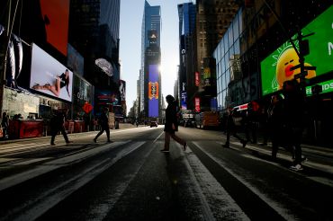 People walk through Times Square on December 2, 2022 in New York City. New York City tops on the Economist Intelligence Units most recent Worldwide Cost of Living index. Its the first time New York City has topped the rankings. 
