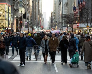 People walk along Fifth Avenue during the Open Streets program during its last day on Dec. 18, 2022 in New York City.