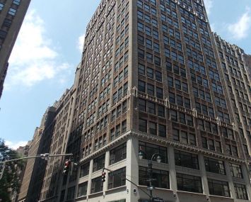 The tall brown building at 462 Seventh Avenue.