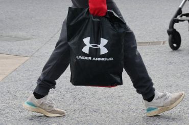 CENTRAL VALLEY, NY - NOVEMBER 17:  A person carries an Under Armour bag at the Woodbury Common Premium Outlets shopping mall on November 17, 2019 in Central Valley, New York. (Photo by Gary Hershorn/Corbis via Getty Images)