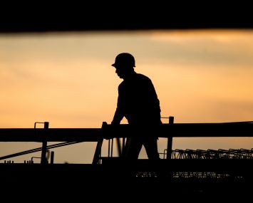 The silhouette of a construction worker.
