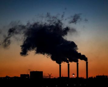 Smoke coming out of stacks in a power plant.